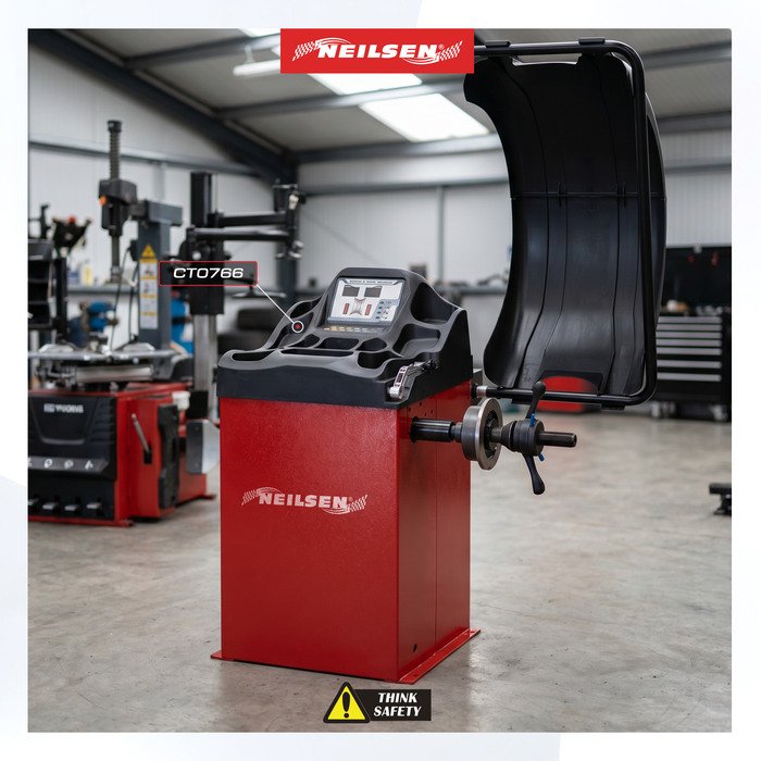 A red and black Neilsen CT0766 Tyre changing machine in a workshop setting, with the protective cover open and a digital control panel on top.